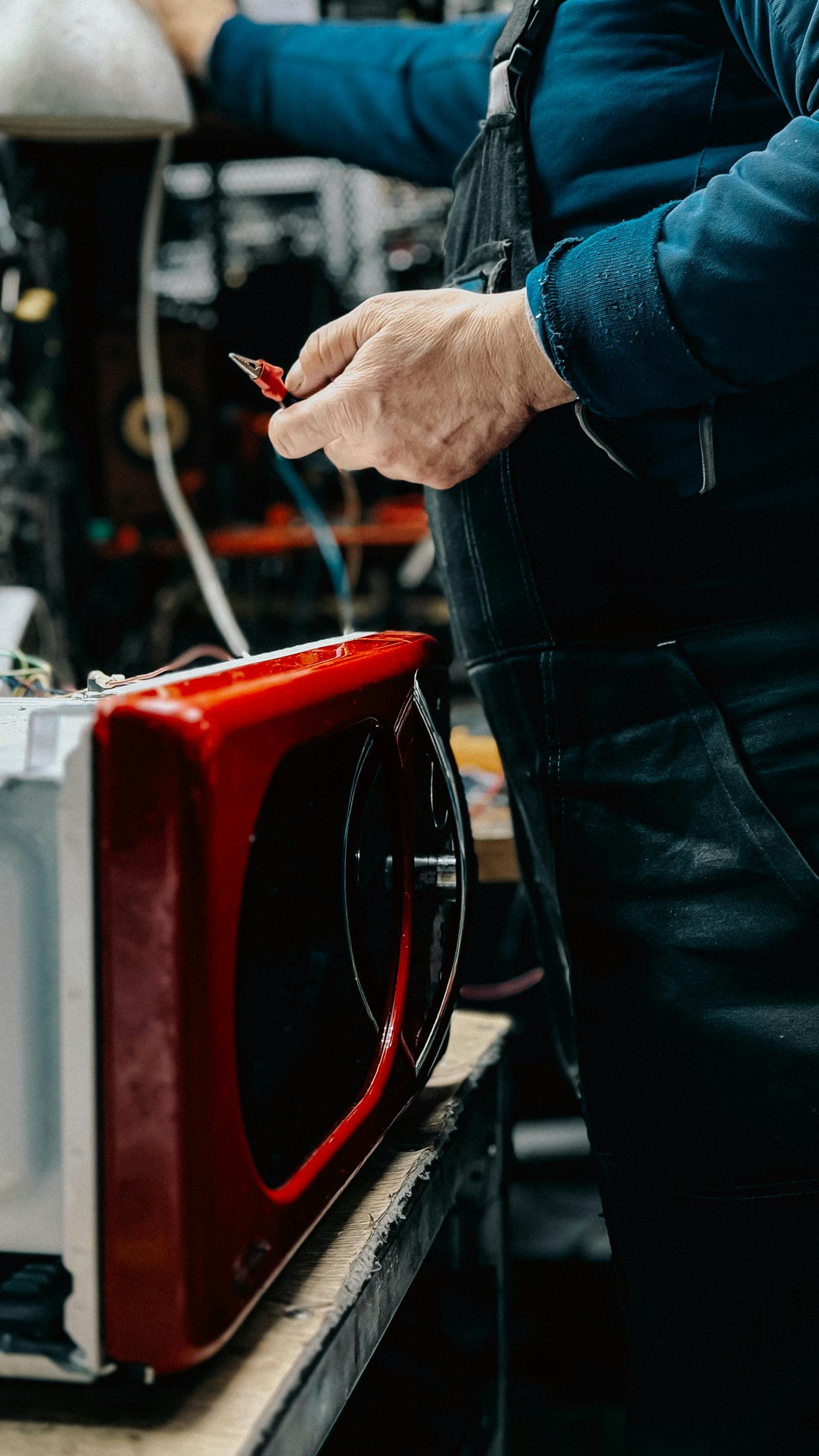 Certified technician diagnosing a microwave in the workshop
