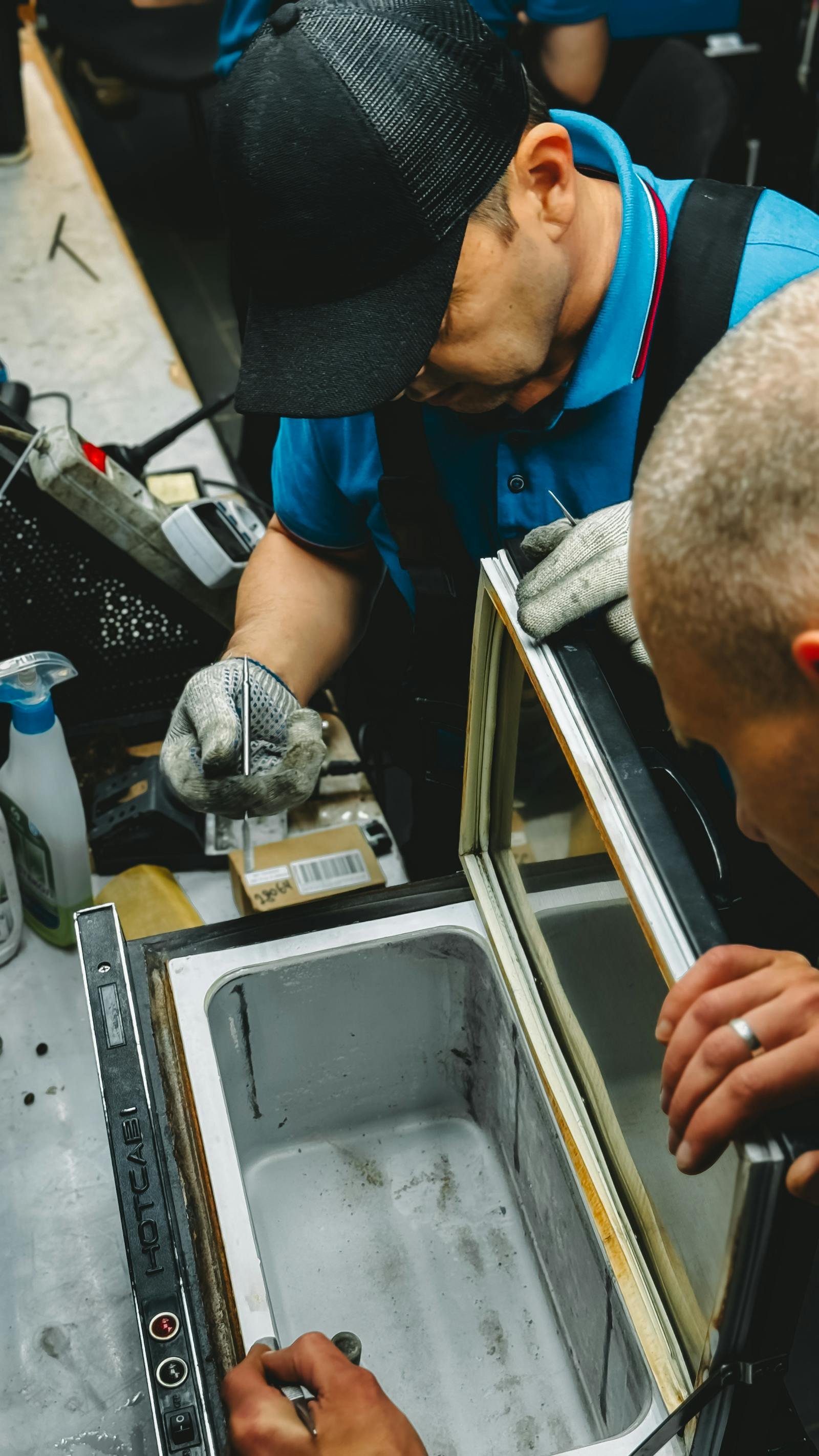 Technician troubleshooting and repairing Refrigerator Repair