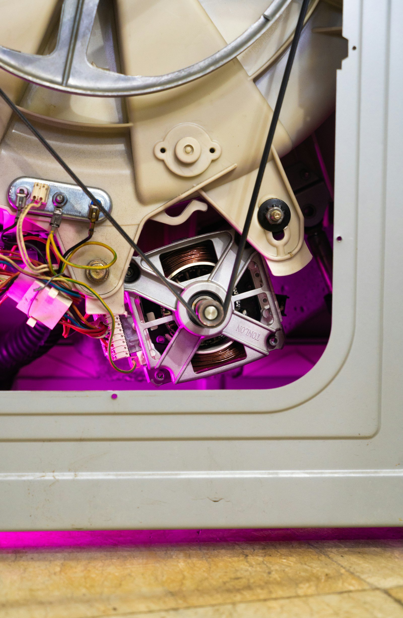 Technician troubleshooting and repairing Washer Repair